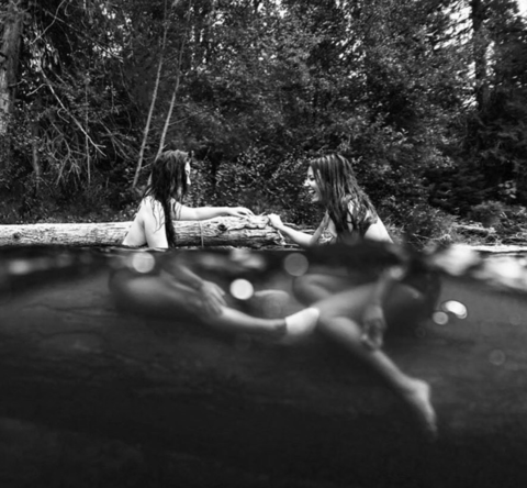 Two models outside in a body of water sharing their moontimes