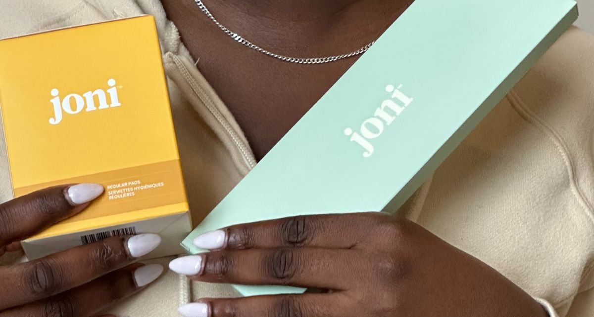 Black woman holds joni period care products