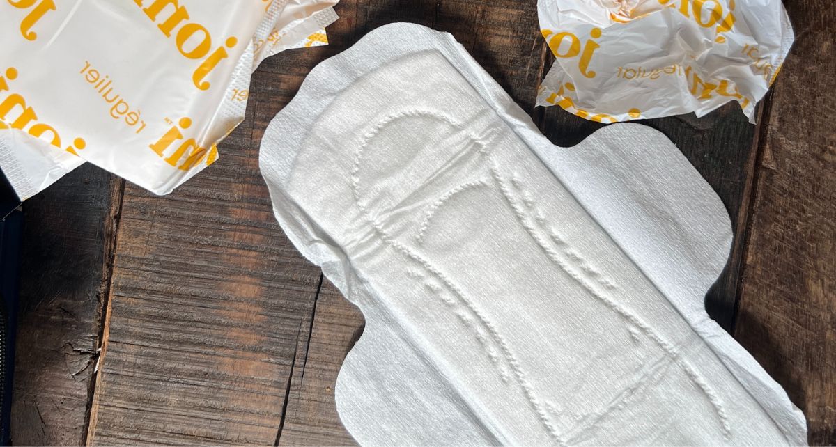 Opened plant-based joni pad with biodegradable wrapper on a countertop