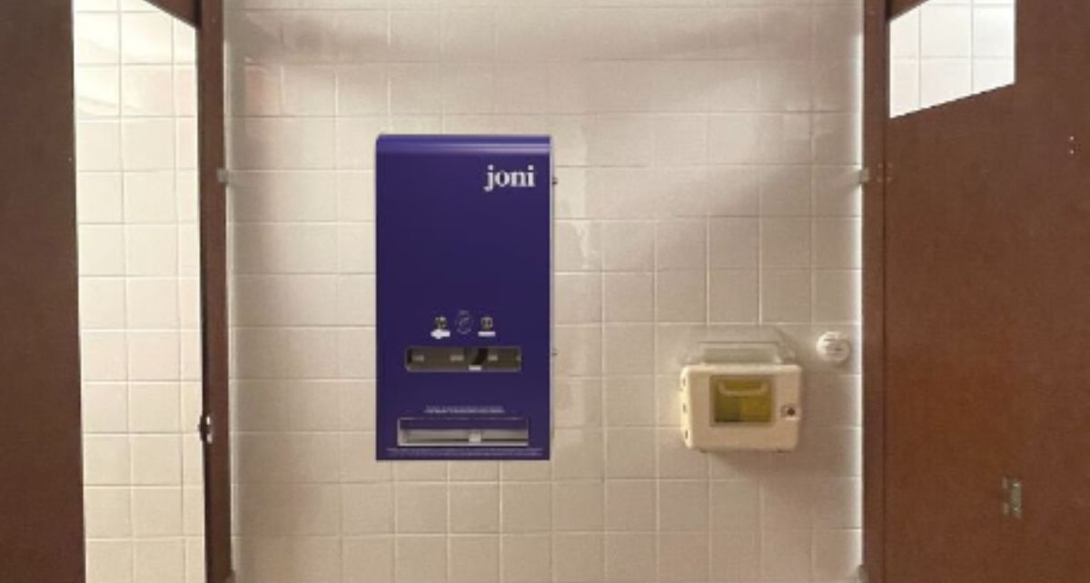 joni period care dispenser hangs on a campus bathroom wall