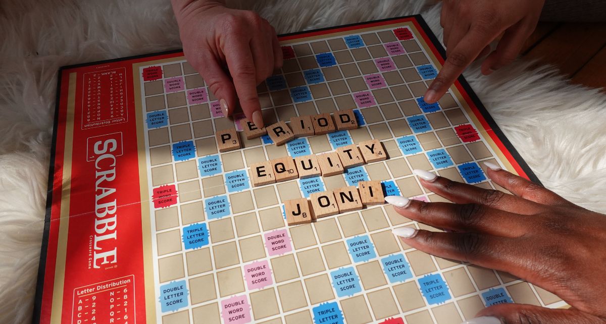 Scrabble board game with words "period equity"