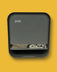 joni menstrual dispenser with non-applicator tampons on a vibrant yellow background.