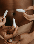 Hands holding regular organic cotton tampons without applicators, promoting eco-friendly menstruation solutions.
