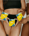Three individuals holding joni boxes, promoting menstrual health and period products for women.
