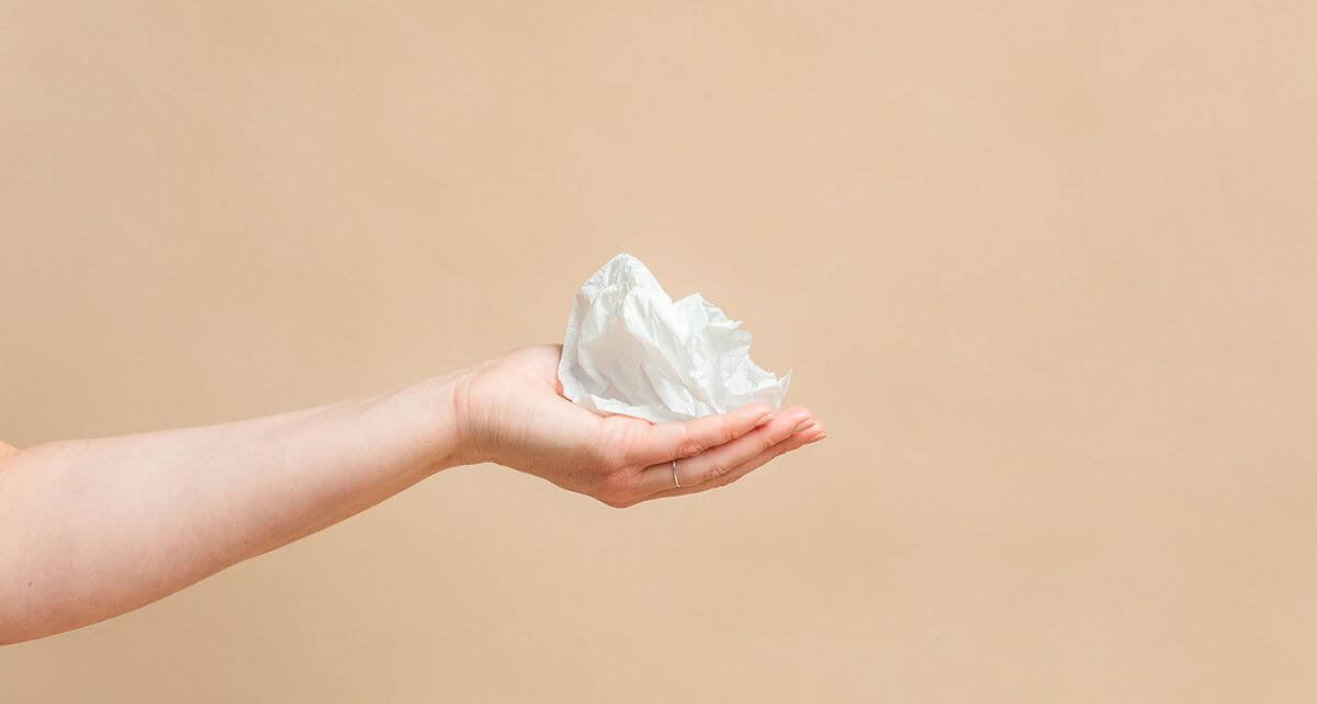 Hand holding compostable bioplastic wrapper from joni pads