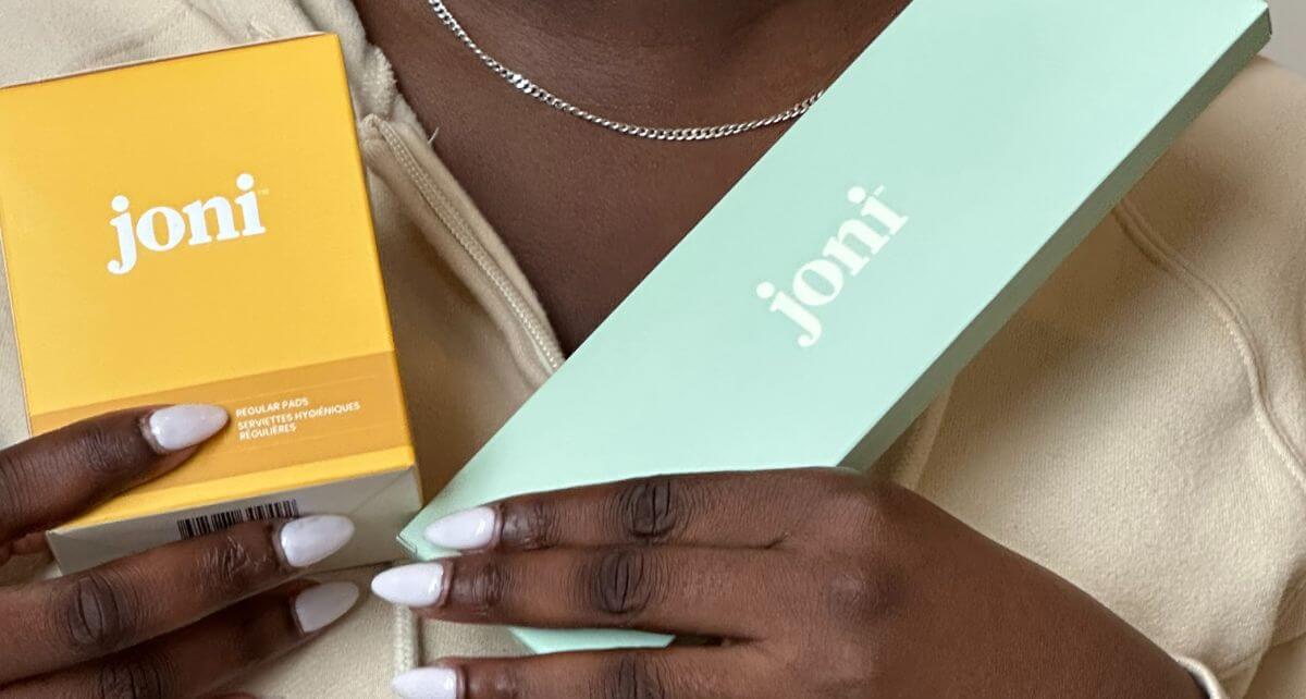 Black woman holds joni period care products