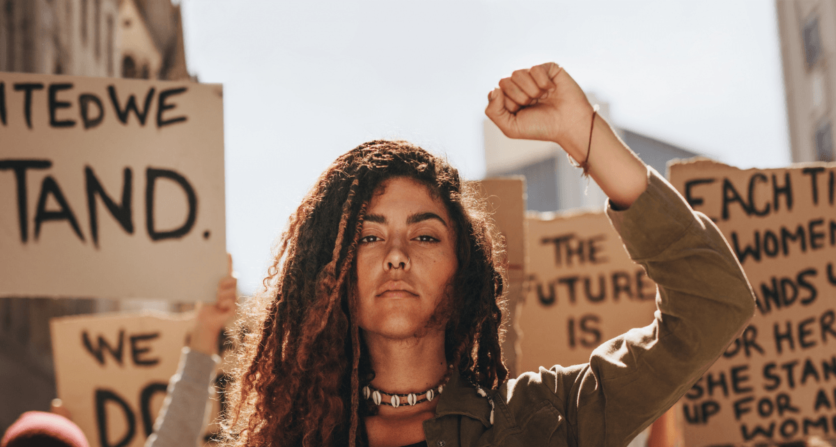Protestors with signs fighting for equity