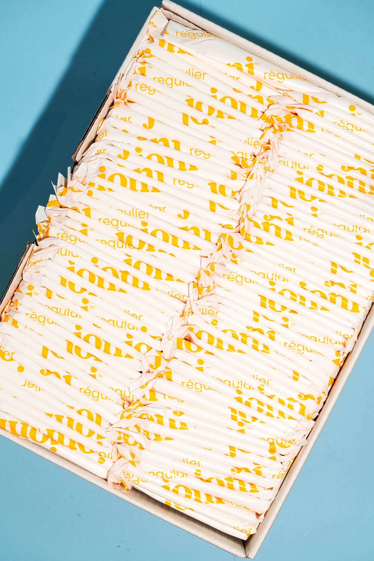 joni regular organic bamboo pads individually wrapped in biodegradable biofilm with joni printed on them in yellow