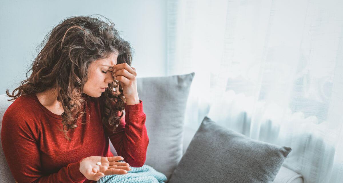 Woman on her period struggling with a headache