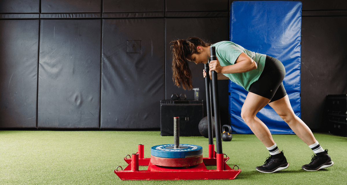 A woman on her period weight training