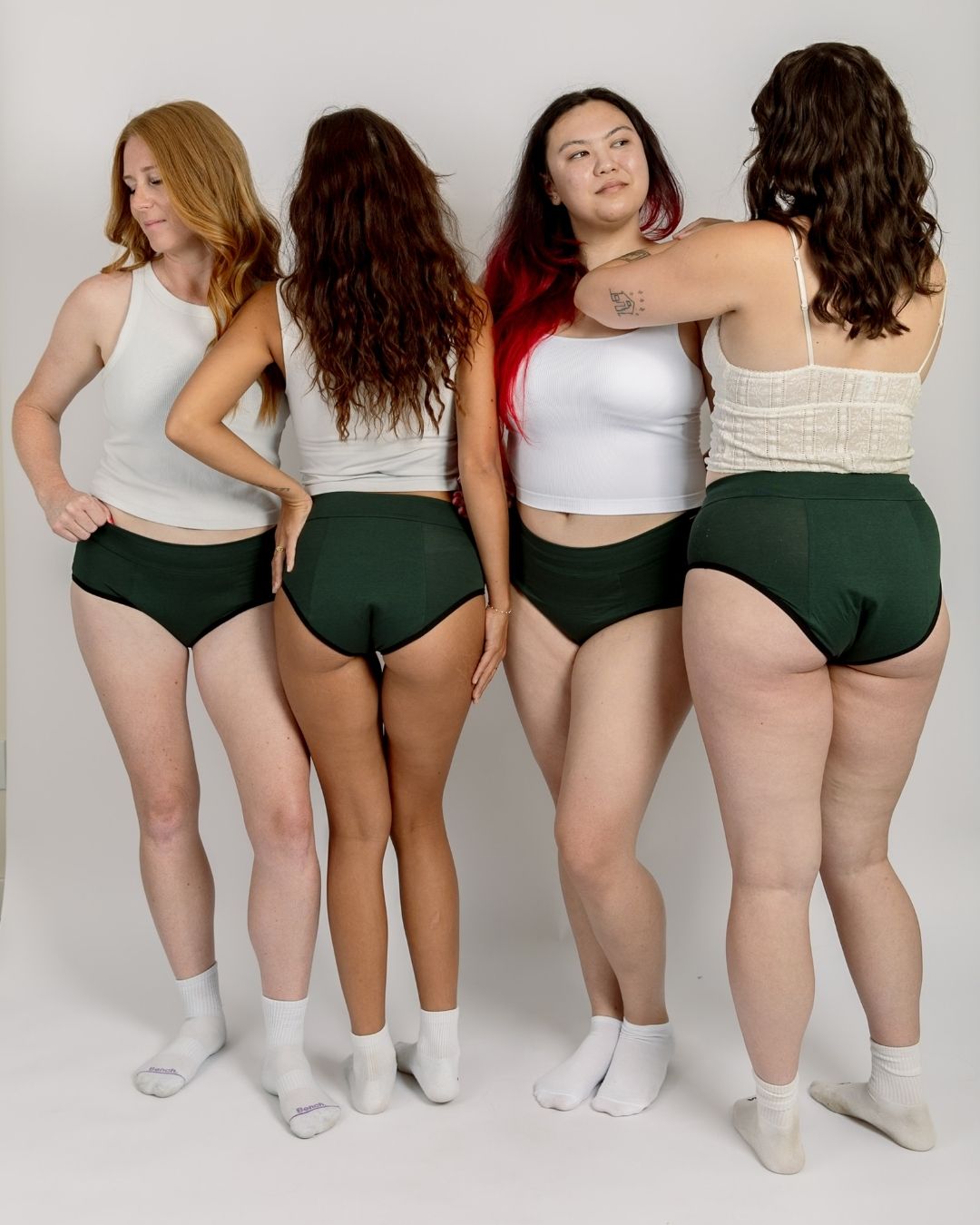Four women in joni's period underwear in white tanktops