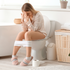 A woman on her period sitting on the toilet wondering why her period makes her poop so much
