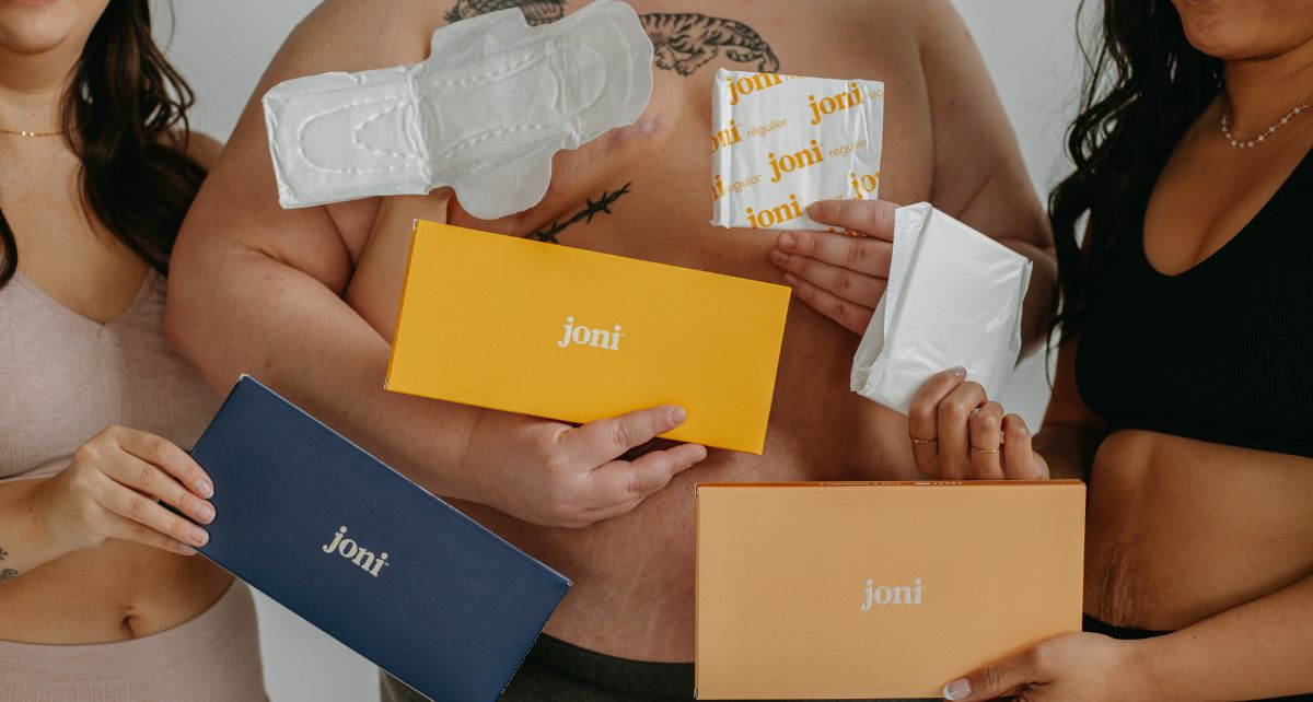 Two woman and a man in underwear hold joni period care