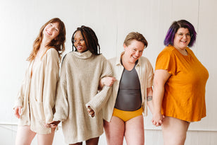 Four diverse people smile, representing joni's mission for menstrual equity