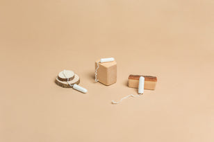 joni regular, super, and super plus tampons displayed on wood blocks to reflect 100% natural organic cotton tampons free from titanium dioxide.