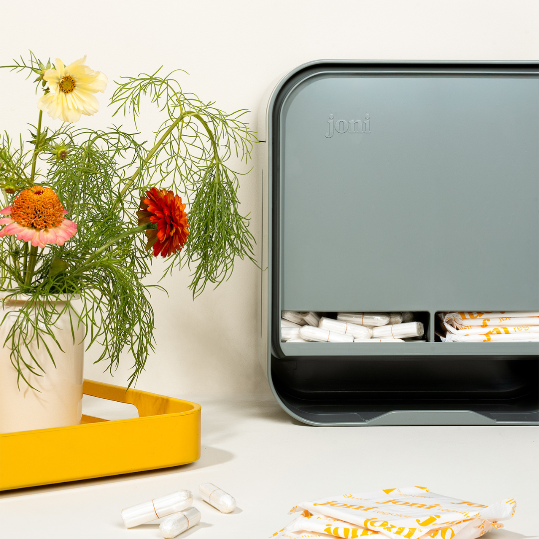 joni model A open dispenser for period products sits on a countertop