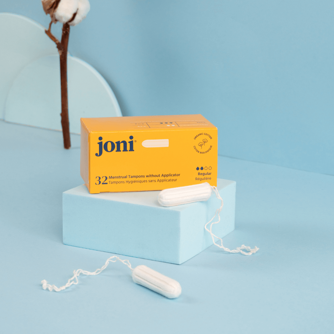 Joni tampons and packaging on a light blue background