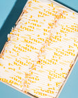 Yellow bulk box of joni regular pads with a blue background 